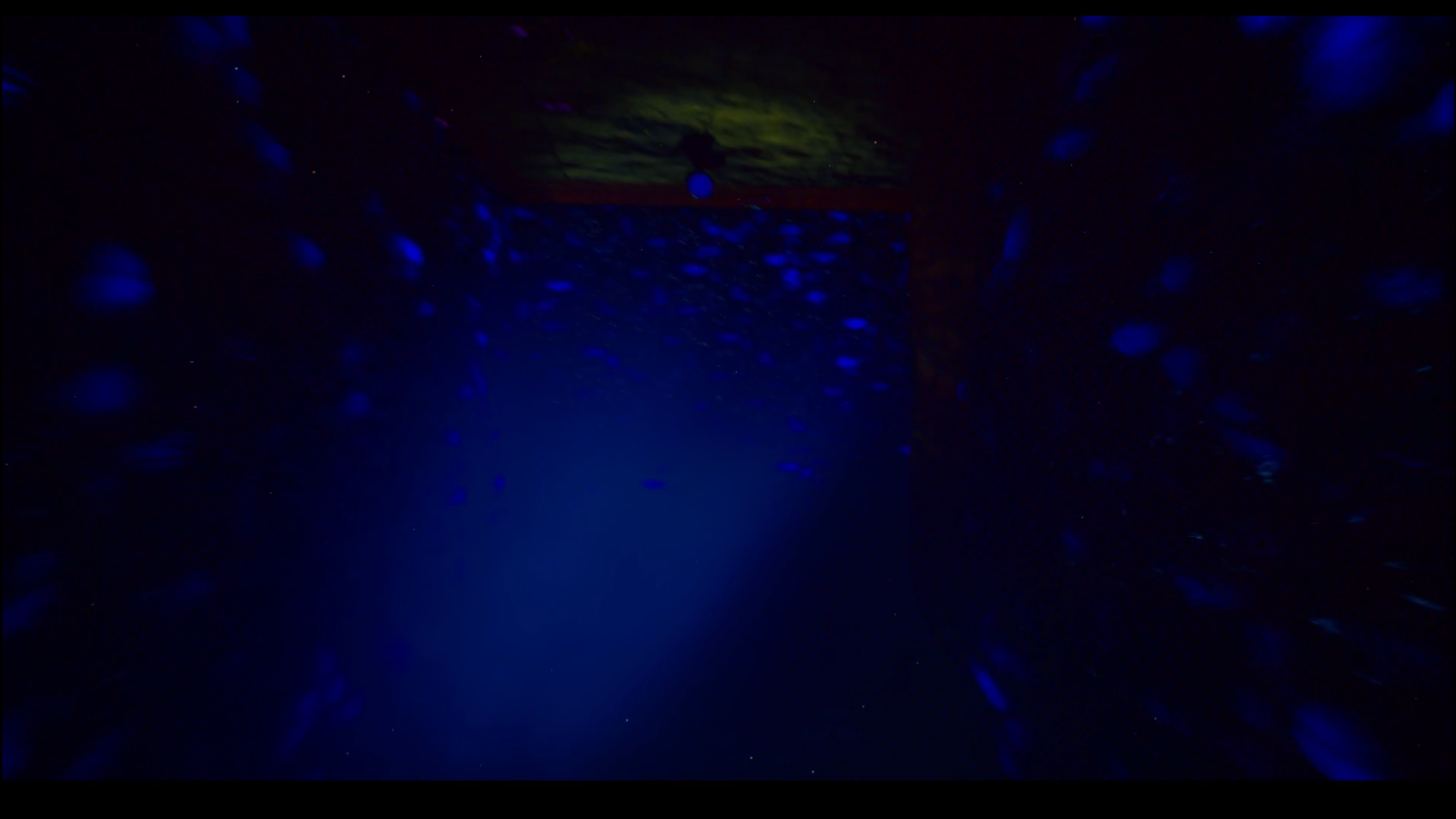 First person looking at a surveillance camera in a purple corridor.